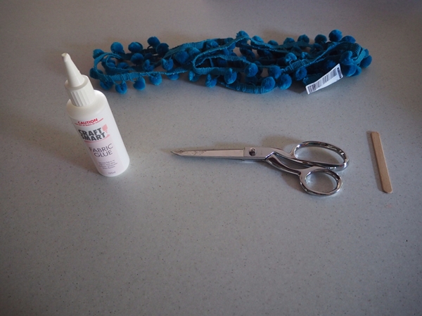 Fabric Glue, Pom Pom trimming, Fabric scissors and a paddle pop stick