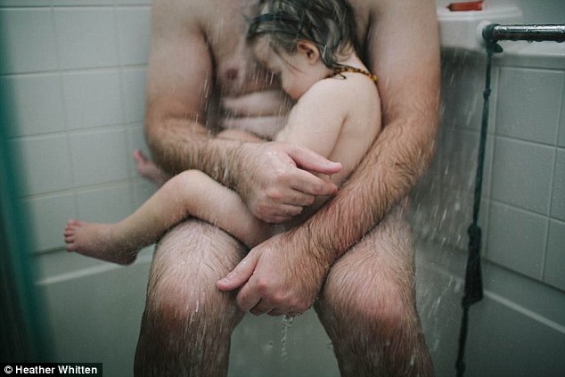 dad holding son in the shower